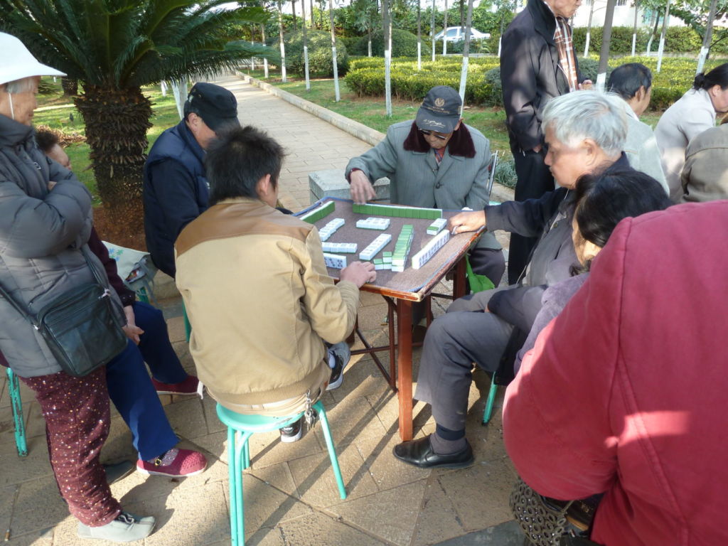 Men sitting around playing a board game