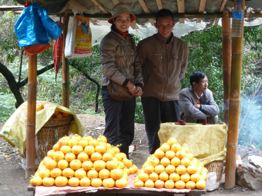 People by oranges