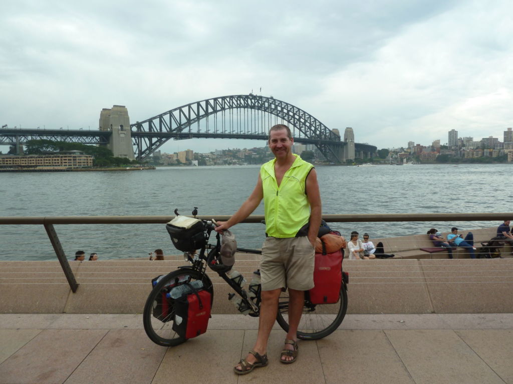 Man with bike by bridge