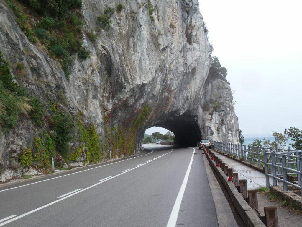 Road going through rock tunnel