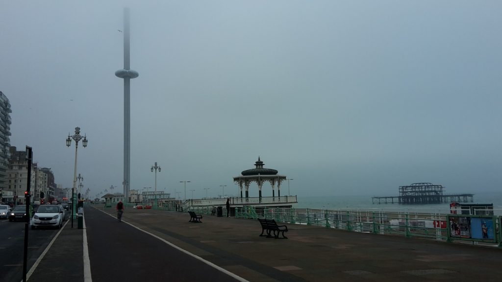 Brighton seafront with the old West pier and the new i360