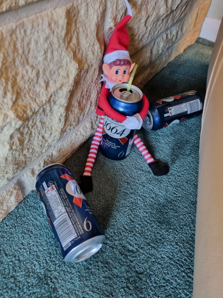Toy elf with cans of beer