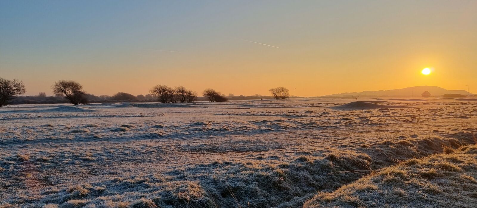 Sunrise over frosty field