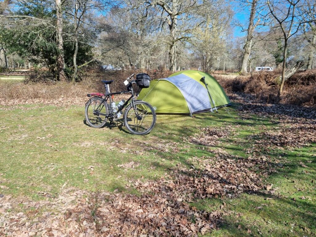 Bicycle, tent in woods