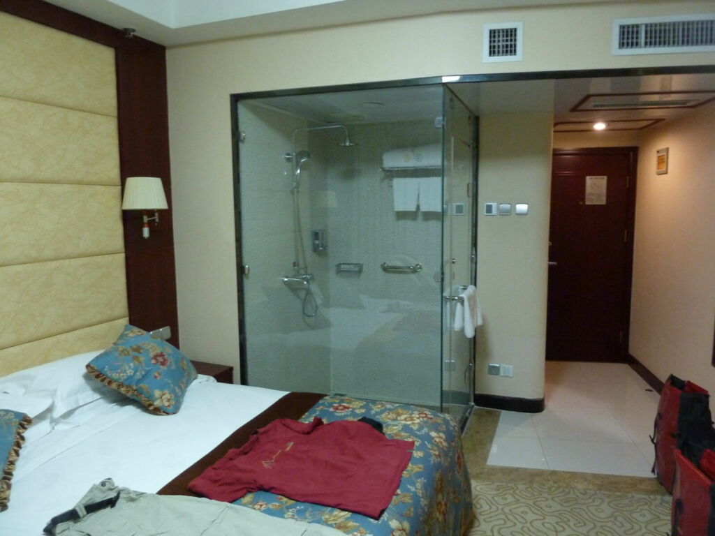 Hotel room with open shower in corner