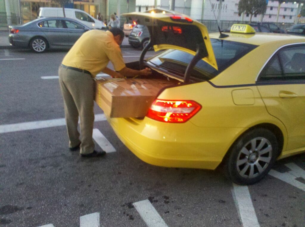 Man putting box in a car